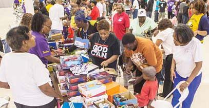 Last year’s event: Parents brought their children to look over the shoe offerings as hundreds waited their turn at the host site, Second Baptist Church on South Side.