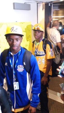 Jackie Robinson West Little League teammates, Pierce Jones and Trey Hondras take in the crowd as the exit an airplane at Chicago's Midway International Airport, 5700 S. Cicero Ave., upon returning home as Little League Baseball’s 2014 World Series, U.S. Champions. 