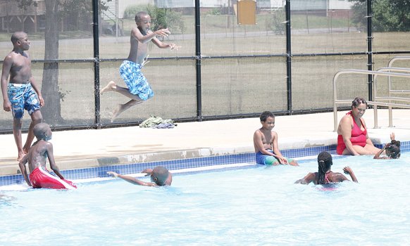 Children enjoy a splash in the city's Fairmount Pool in the East End. They're starting to take their final dips as the city will close all of its outdoor pools when schools reopen Tuesday.