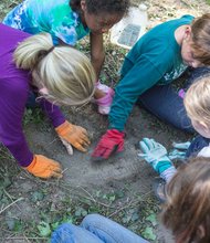 Girl Scouts spruce up at East End Cemetery one of four cemeteries at Evergreen. 