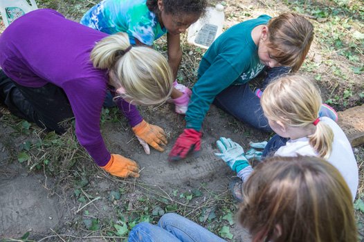 Girl Scouts spruce up at East End Cemetery one of four cemeteries at Evergreen. 