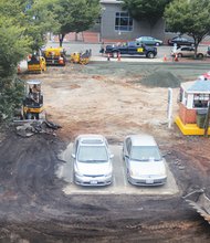 Parking for two is all that is left as workers clear a lot for an asphalt resurfacing. Location: Franklin Street between 4th and 5th streets in Downtown. The old asphalt removal and repaving took two days last week and left a shiny new surface.