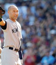 New York Yankees shortstop Derek Jeter doffs his cap to the Fenway Park crowd Sunday. The Boston Red Sox honored Jeter before the game, his last in Major League Baseball.