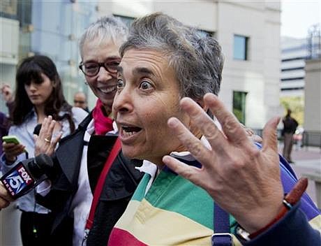 Rhonda Buckner, right, and her partner Diana Ullius, celebrate outside the Arlington County Courthouse in Arlington, Va., Monday, Oct. 6, 2014, following a Supreme Court decision rejecting gay marriage appeals from 5 states. Buckner and Ullius, met in 1981 and were married in in Canada on Sept. 2, 2006. The Supreme Court cleared the way Monday for an immediate expansion of same-sex marriage by unexpectedly and tersely turning away appeals from five states seeking to prohibit gay and lesbian unions. The court's order effectively makes gay marriage legal in 30 states. (AP Photo/Manuel Balce Ceneta)
