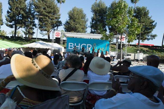 Spectators enjoy the shade as the Michael Ward band performs at IBEW Local 18 and Baldwin Hills Crenshaw Union Jobs Expo and Celebration featuring over 20 community organizations sharing information about job training opportunities.