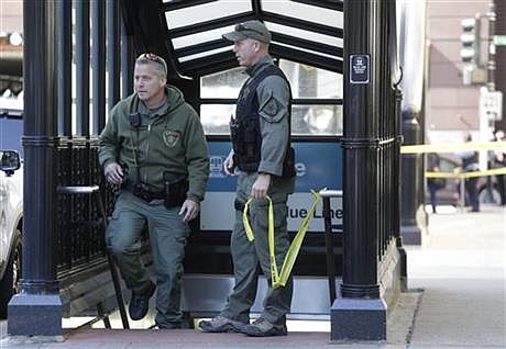 Members of the Chicago Police Department's SWAT team exit a Chicago subway station where police say a gunman standing on a subway platform opened fire on a commuter train, Thursday, Oct. 9, 2014, in Chicago. The shooting occurred at the LaSalle Street Blue Line station in the city's financial district. Chicago Police spokesman Martin Maloney says officers arrested a suspect a short distance away after the shooting and recovered a weapon. No injuries were reported. (AP Photo/M. Spencer Green)
