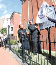 Dr. Rodney D. Waller, pastor of First African Baptist Church on North Side, unveils a state historical marker commemorating one of the city’s oldest black churches. An appreciative audience watches the ceremony at the original site of the church.