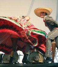 Mexican Mariachi dancers show off fancy footwork during their performance.