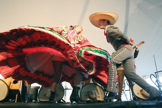 Mexican Mariachi dancers show off fancy footwork during their performance.