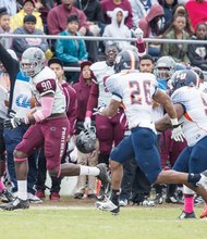 VUU’s Darrell Lamb completes a reception as fans and teammates cheer him on. The VUU Panthers were victorious, 78-13. 