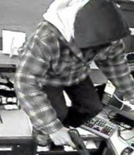 This photo, captured by a surveillance camera, reportedly shows Carl Wilson climbing over a teller counter while robbing a First Midwest Bank in Orland Park.