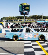 Darrell Wallace’s truck crosses the finish line at the Kroger 200 in Martinsville. It is painted and numbered for NASCAR Hall of Fame Inductee Wendell Scott.