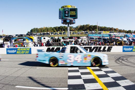 Darrell Wallace’s truck crosses the finish line at the Kroger 200 in Martinsville. It is painted and numbered for NASCAR Hall of Fame Inductee Wendell Scott.