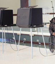 Maggie Ingram gets an escort from the voting station from her daughter Almeta Ingram Miller. 