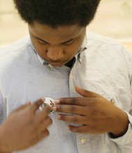 Kentrell Miller, 18 proudly sticks the I voted sticker on his shirt. 