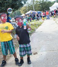 Christopher Bradley, left, and Caser Bradley make bubbles while wearing colorful face paint. They were among hundreds of people who enjoyed the 10th Annual Imagine Festival on Oct. 18. Location: Broad Rock Sports Complex on South Side. The event celebrates diverse communities with musical and dance performances, arts and crafts, food, sports and other activities.