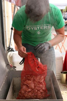 Chris Robertson of Rappahannock River Oysters prepares oysters for shucking.  