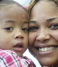Sisters Heaven and Ayisha Carter, 24, joyfully celebrate after the older sibling receives final approval for adoption of the 2-year-old toddler during the National Adoption Day ceremony in Richmond.