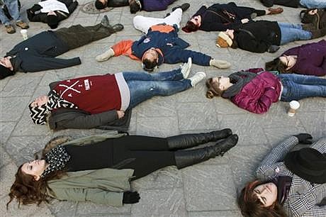 Protesters stage a die-in on Thursday afternoon, Dec. 4, 2014, at Campus Martius park in downtown Detroit in a rally over the non-indictment of Eric Garner, a black New York man who died during a police arrest. (AP Photo/The Grand Rapids Press, Elaine Cromie )