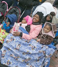 Parade-goers stay warm as they enjoy the array of floats, marching bands and even an appearance by Santa Claus.