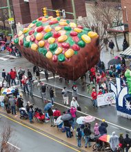A colorfully decorated fruitcake balloon, sponsored by the Science Museum of Virginia, has a commanding presence along the parade route. 