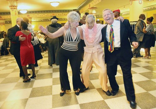Ninety-six-year-old Lulu Gault, center, boogies with with Judith and Ike Koziol at the Dec. 4 Holly Ball event — billed as an “evening of holiday joy.” Location: The ballroom in the Altria Theater.