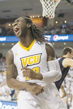 VCU’s Mo Alie-Cox reacts after dunking the ball against the University of Virginia during last Saturday’s game.