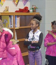 Gwen Drayton, left, co-chairwoman of the Richmond Continentals’ Gift of Warmth Committee, checks sizes before handing out coats Dec. 3 at Blackwell Elementary School on South Side. The Continentals gave out 300 coats at several city schools this year.