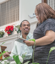 Cory Todd, 25, presents his mother, Cynthia Todd, with a “God Chose Me” award during Second Baptist Church’s recent Christmas celebration spotlighting the talents and contributions of people with special needs and their advocates.