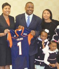 New Virginia State University football coach Byron Thweatt is flanked from left by VSU interim President Pamela V. Hammond; Athletic Director Peggy Davis; his wife, Mieya; and their three daughters, 2-year-old Bralynn (being held), 7-year-old Brianna and 4-year-old Bryce.
