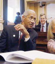 Delegate Morrissey, left, distantly checks his work while, beside him, two new delegates, Joseph E. Preston of Petersburg and Kathleen Murphy of Loudoun County, enjoy their first day at the new session in the House of Delegates.