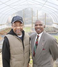 31st Street Baptist Church Dr. Morris Henderson, right, stands Tuesday with deacon and urban gardener Lee Marshall inside the hoop house behind the church.