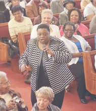 The Rev. Carolyn Clark dramatically presents a soul-stirring song at the Citywide Mass Meeting at Cedar Street Baptist Church of God.