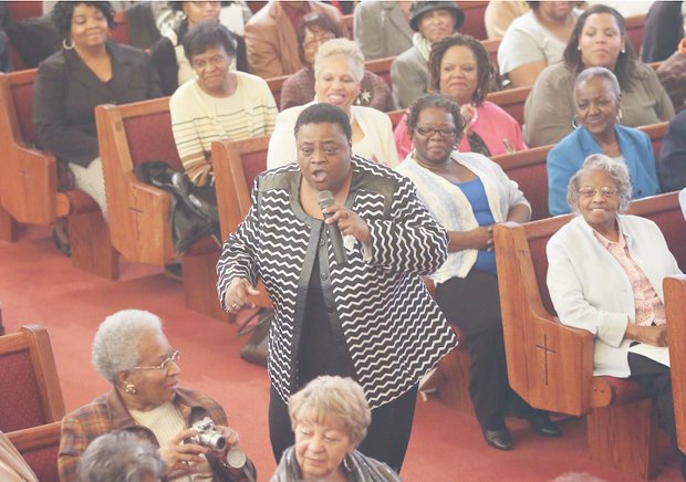 The Rev. Carolyn Clark dramatically presents a soul-stirring song at the Citywide Mass Meeting at Cedar Street Baptist Church of God.