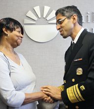 Dr. Vivek Murthy, the nation’s surgeon general, talks with Joyce Pollard of Chesterfield at The Daily Planet in Richmond, where staff helped her sign up for health insurance under the Affordable Care Act.