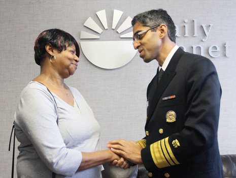 Dr. Vivek Murthy, the nation’s surgeon general, talks with Joyce Pollard of Chesterfield at The Daily Planet in Richmond, where staff helped her sign up for health insurance under the Affordable Care Act.