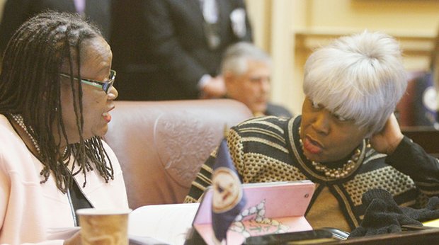 Virginia State Senators Mamie Locke of the 2nd District (Hampton) and L. Louise Lucas of the 18th District (Portsmouth) chat in the Senate chamber before the opening of the 2015 session of the General Assembly on Jan. 14, 2015.