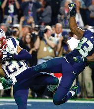 New England’s Malcolm Butler (21) intercepts a pass intended for Seattle Seahawks wide receiver Ricardo Lockette (83) to clinch Super Bowl XLIX for the Patriots on Sunday.