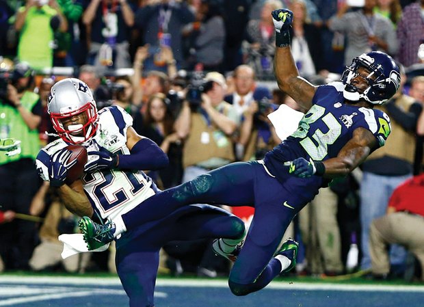 New England’s Malcolm Butler (21) intercepts a pass intended for Seattle Seahawks wide receiver Ricardo Lockette (83) to clinch Super Bowl XLIX for the Patriots on Sunday.