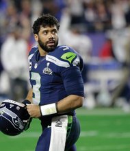 Seahawks quarterback Russell Wilson glances back Sunday after throwing the decisive interception near the end of Super Bowl XLIX.