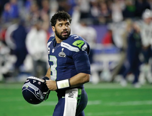 Seahawks quarterback Russell Wilson glances back Sunday after throwing the decisive interception near the end of Super Bowl XLIX.