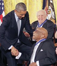 President Obama congratulates Charlie Sifford, the first African-American golfer to play on the PGA tour, after awarding him the Presidential Medal of Freedom in 2014.