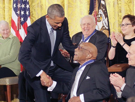 President Obama congratulates Charlie Sifford, the first African-American golfer to play on the PGA tour, after awarding him the Presidential Medal of Freedom in 2014.