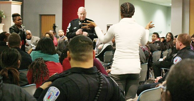 Evandra Catherine asks Richmond Police Officer Jacob DeBoard one of many questions posed Tuesday by community members to department representatives about policing policies during a forum at the Richmond Police Training Academy