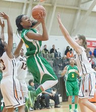 Huguenot High School star sophomore guard Taya Robinson slices through three Monacan defenders en route to the basket in a recent game.