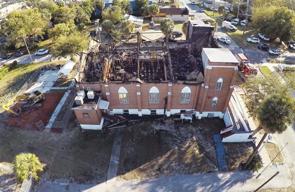 Tampa firefighters battled a blaze at a church led by controversial pastor Dr. Henry J. Lyons, former head of the ...