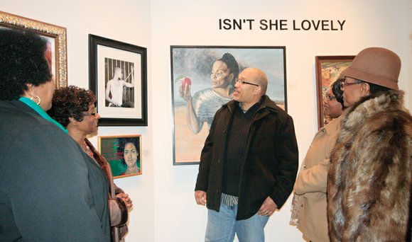 Above, Darryl Wingo, center, discusses his photograph, “Naturally Free,” with art enthusiasts, from left, Patricia Burrell, Arnetha Carter, Michelle Crump ...