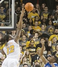 Virginia Commonwealth University’s Mo Alie-Cox stretches skyward to block a shot from St. Louis University’s Ash Yacoubou in Tuesday’s game at the Siegel Center. VCU beat St. Louis 74-54.