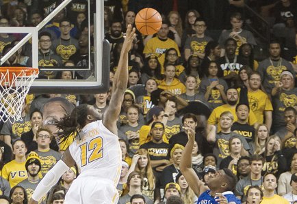 Virginia Commonwealth University’s Mo Alie-Cox stretches skyward to block a shot from St. Louis University’s Ash Yacoubou in Tuesday’s game at the Siegel Center. VCU beat St. Louis 74-54.