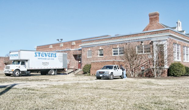 Movers are in place at Elkhardt Middle School to load and haul all school materials across town to Clark Springs Elementary School last Friday.